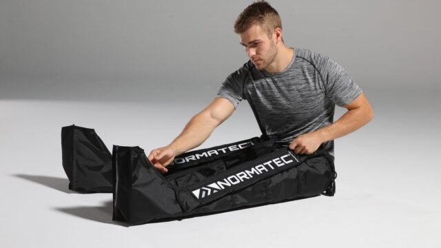 normatec-2664-steve-boots-floor-zipping.jpg