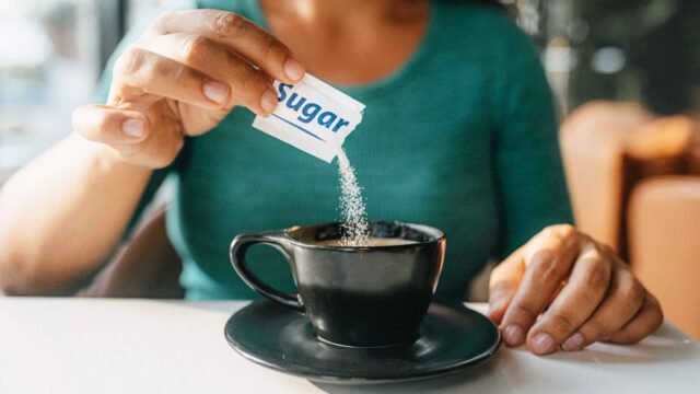 person-adding-sugar-to-coffee.jpg