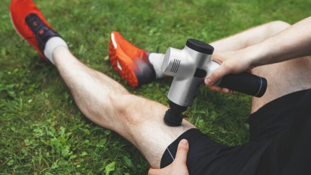 person-using-massage-gun-after-race.jpg